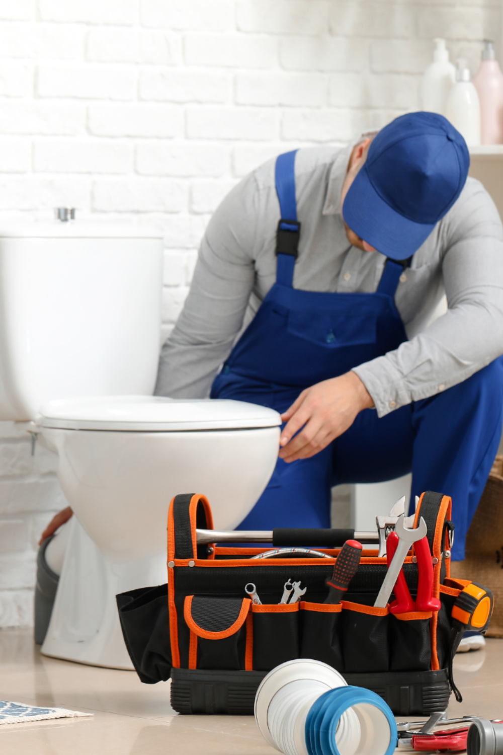 plumber fixing toilet