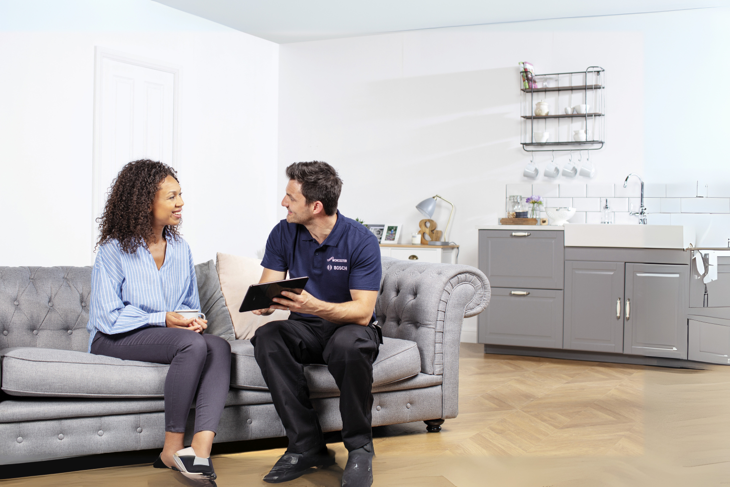 man and woman sat looking at computer